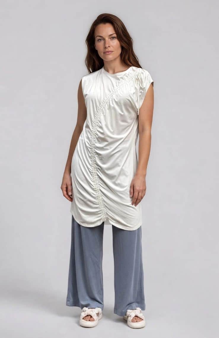 This relaxed-fit tunic features a curvy gathering on the front for added detail. The round neckline and dropped shoulders create a comfortable and stylish look. The viscose jersey fabric with slight stretch ensures comfort and ease of movement.